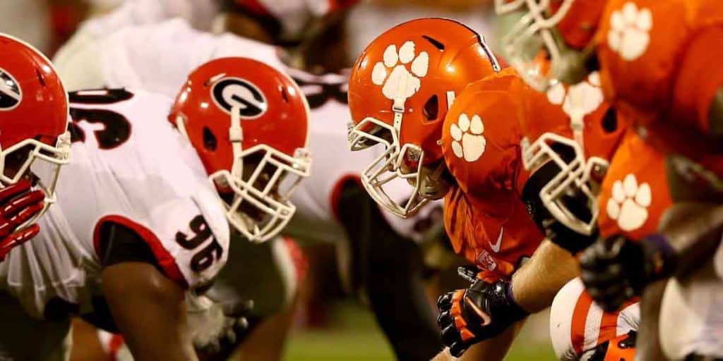 The Georgia Bulldogs offensive line about to snap the ball against the Clemson Tigers defensive line